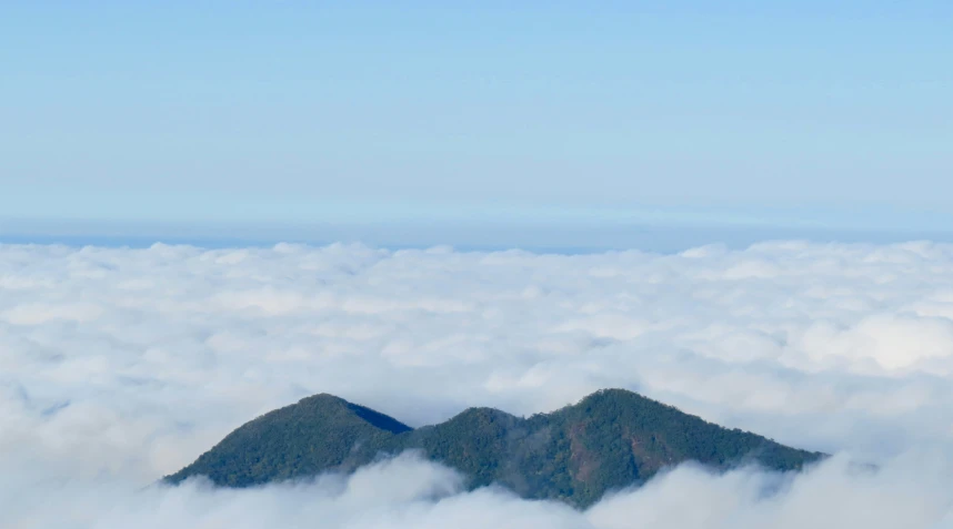 an image of a mountain above the clouds