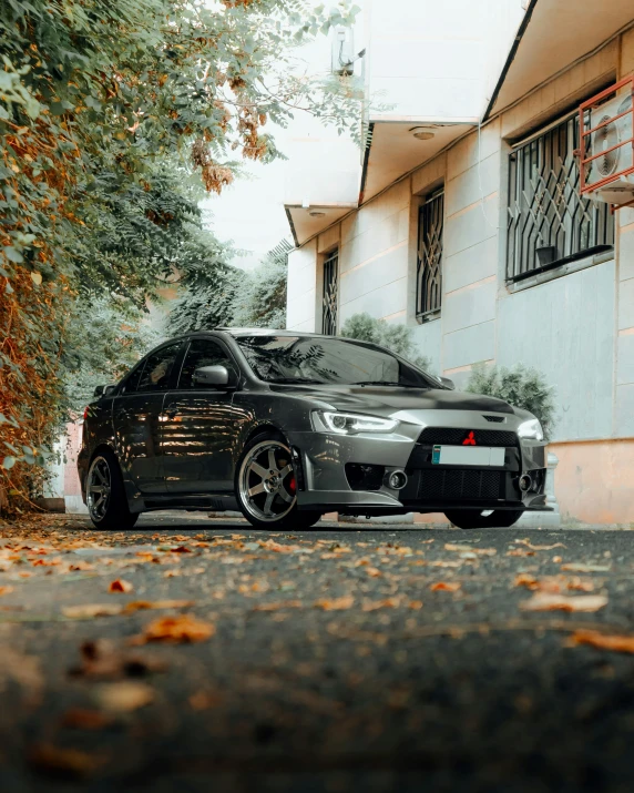 a black sporty car is parked on the street