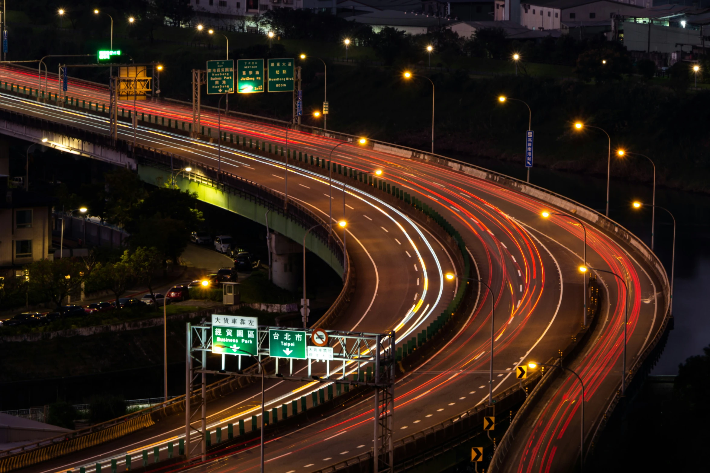 a busy highway lit by various colorful traffic lights