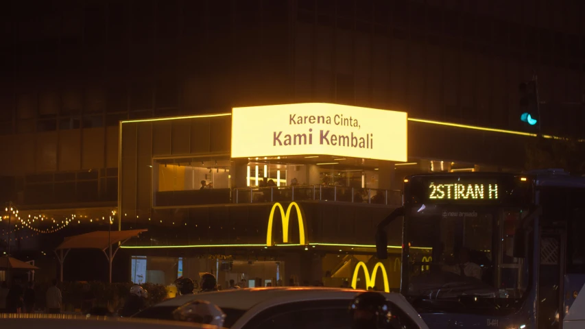 the mcdonald's building is lit up at night