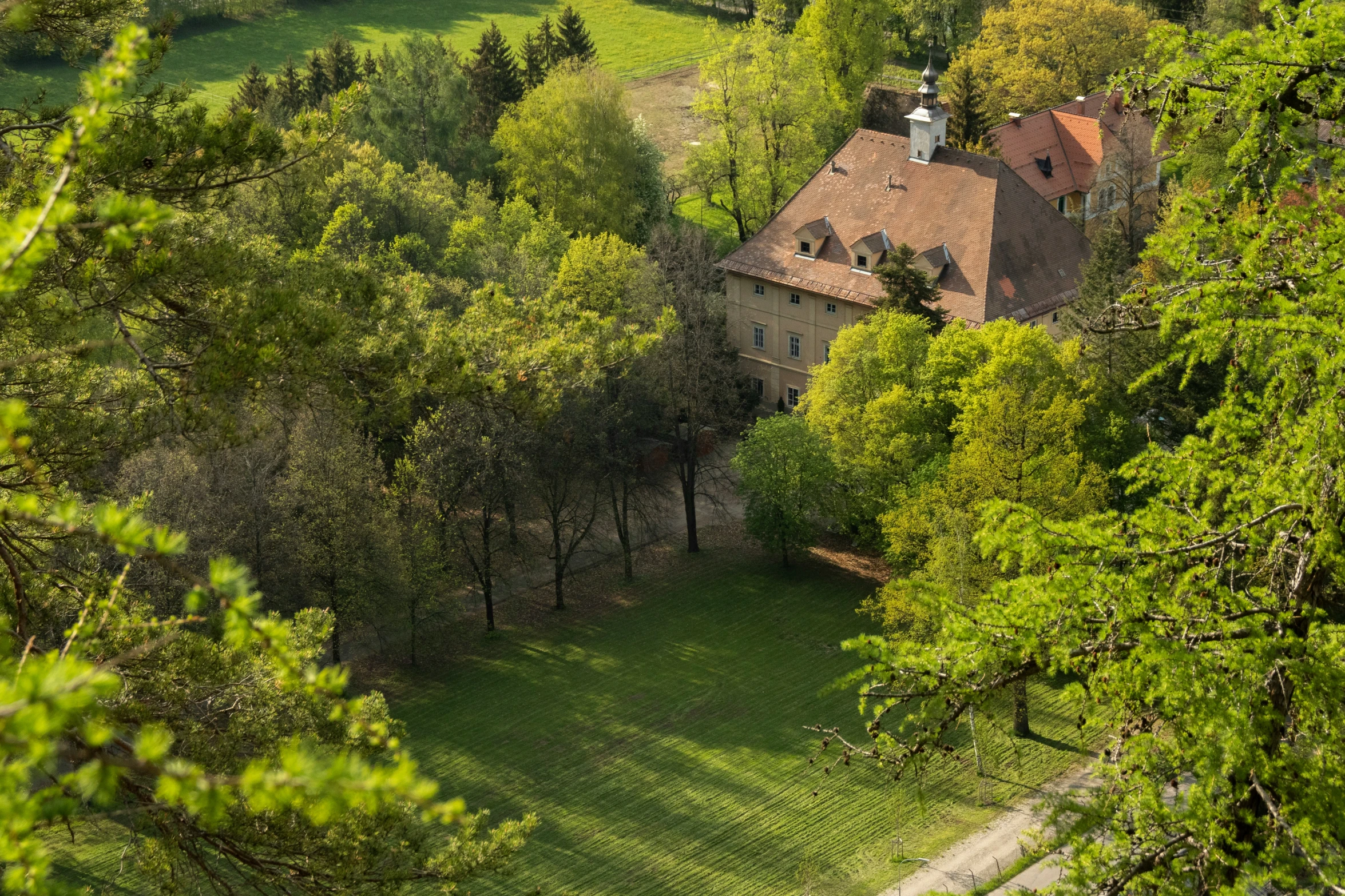 an aerial view of a home with trees in the background