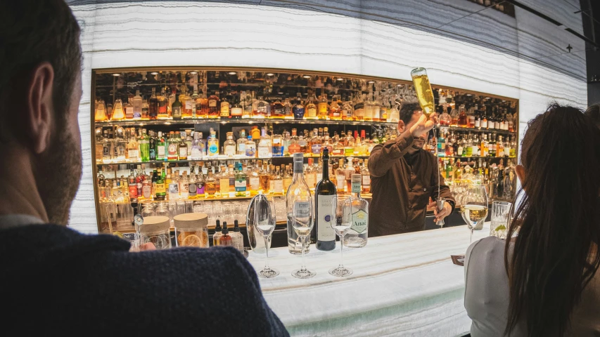 people are looking at the bottles in a liquor store