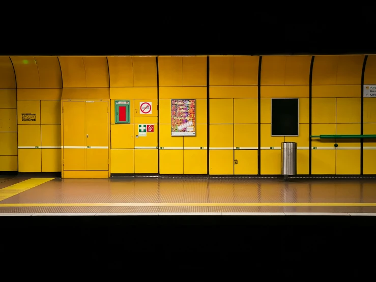 a bus stop has yellow boxes behind it