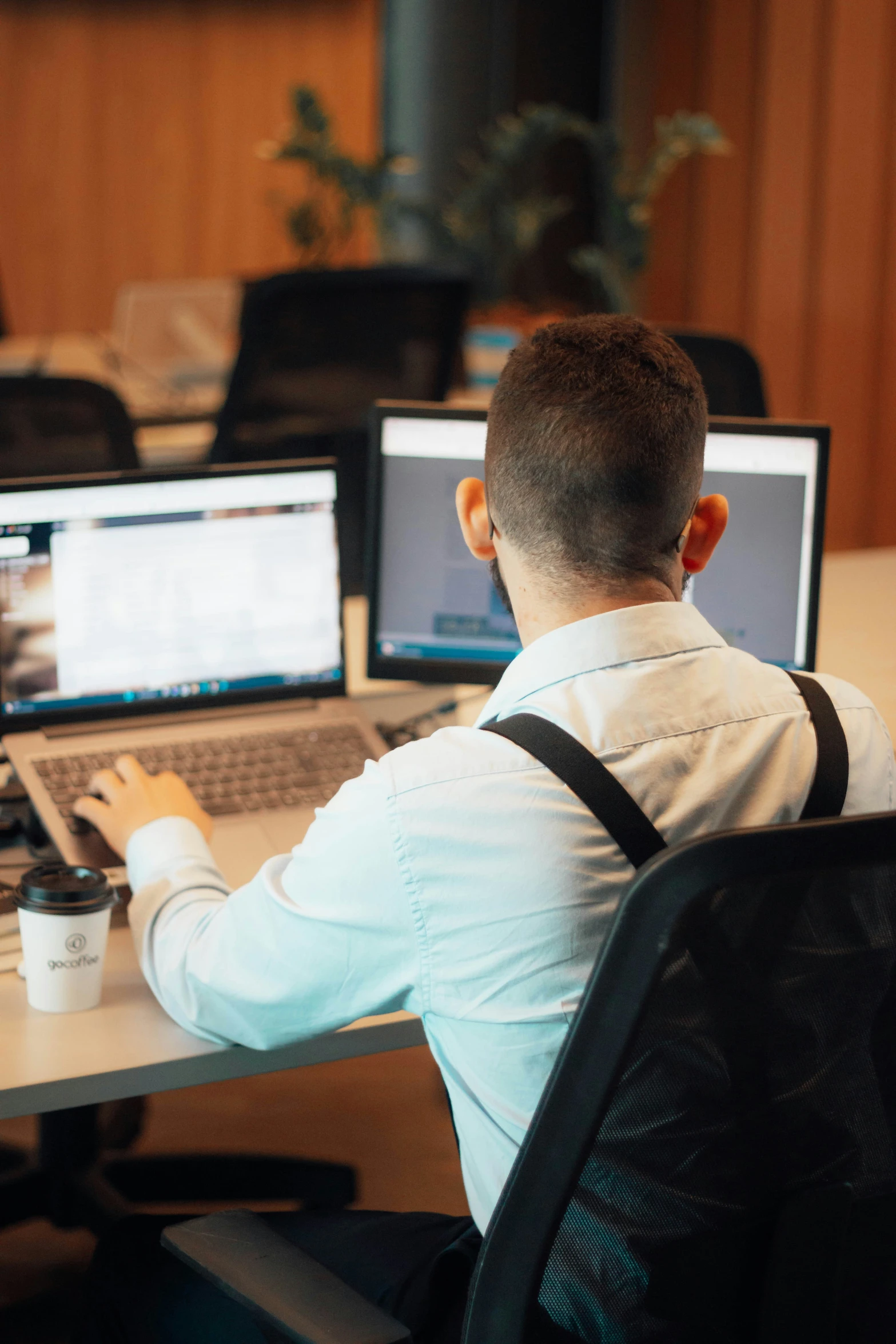 a man is sitting in front of his computer