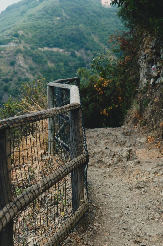 a rusty gate sitting above the top of a hill
