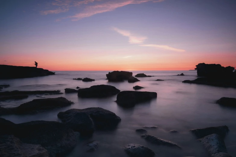 a man is standing on a rock formation