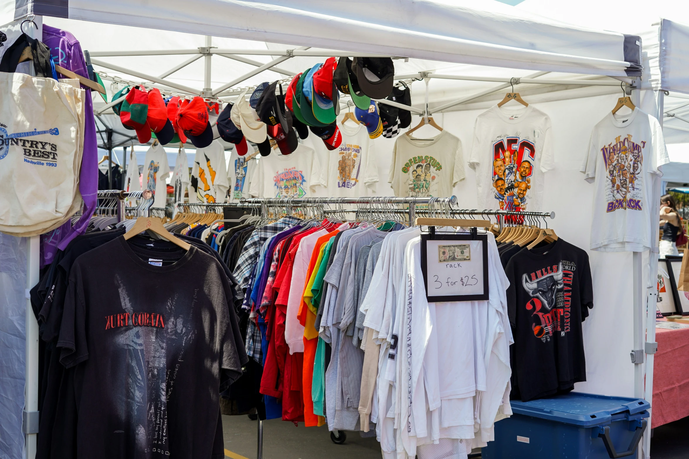 a group of clothing is being sold in a booth