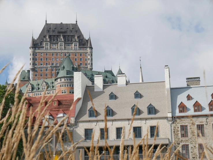 a large castle like building with turrets, and tall buildings