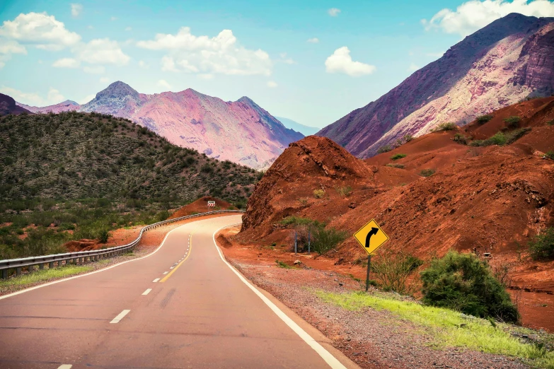 an image of an empty road and mountains