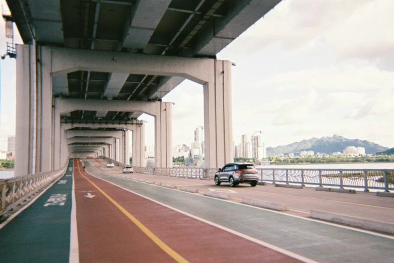 an overpass with a red line and yellow stripe along the side