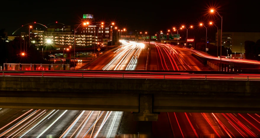 the city is lit up at night with long exposures