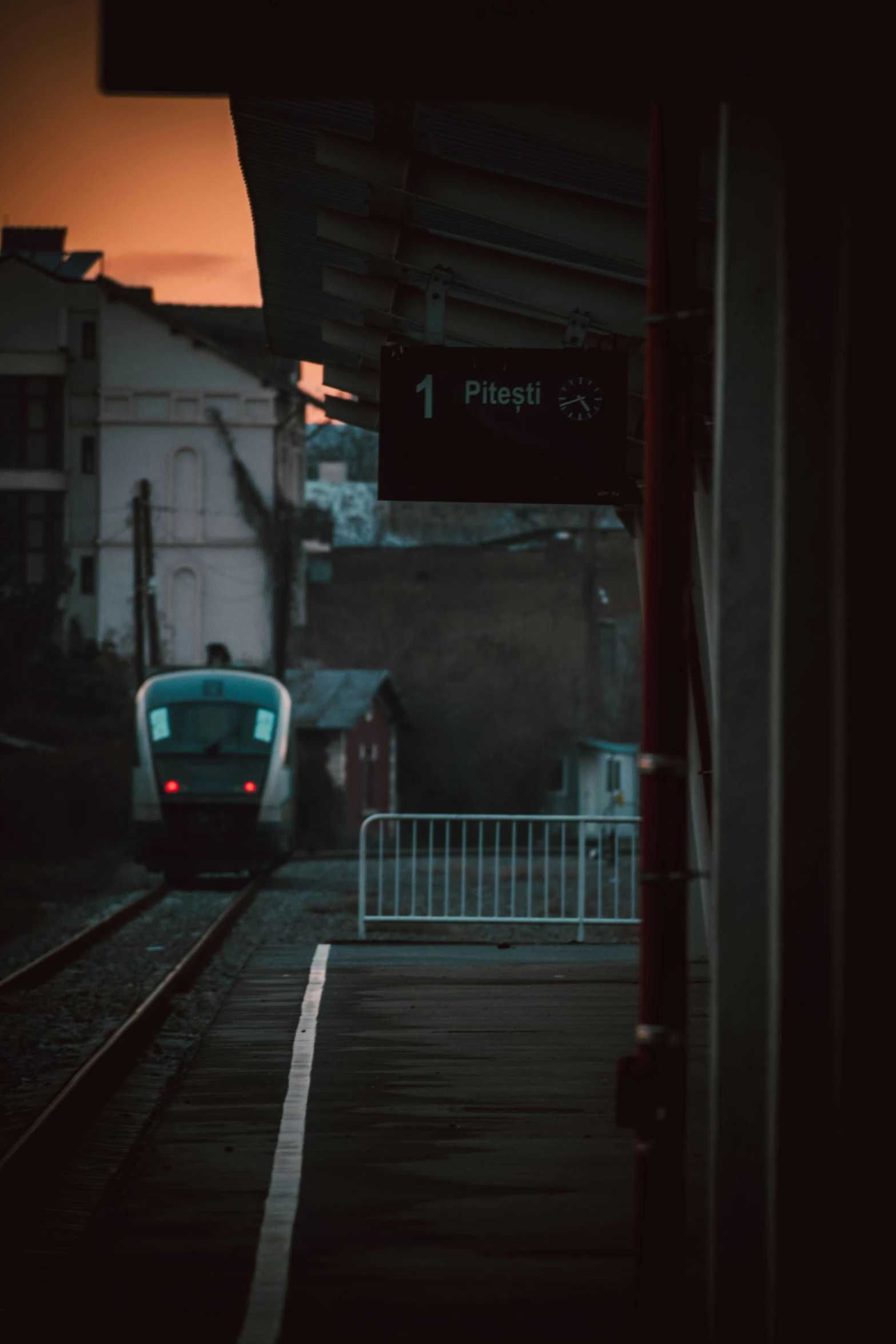 a train riding along tracks near buildings and street lights