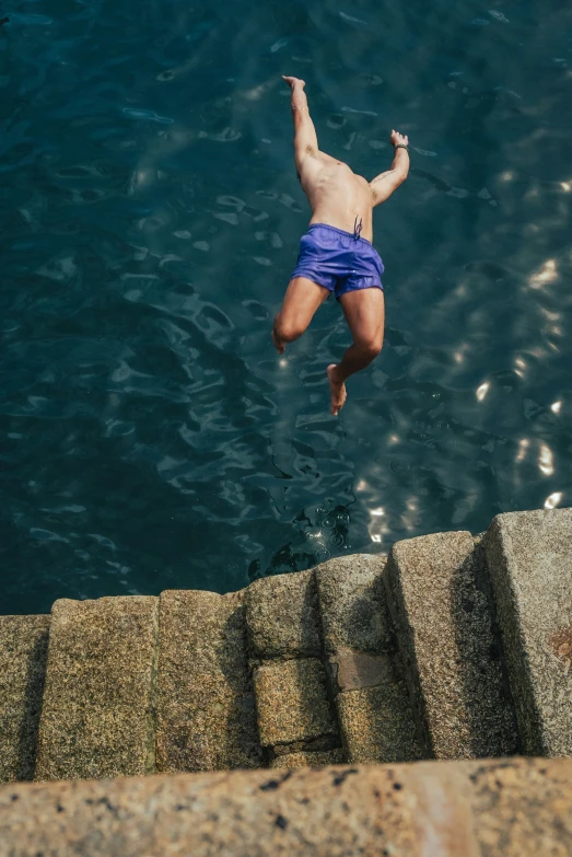 there is a man standing on the stairs and diving