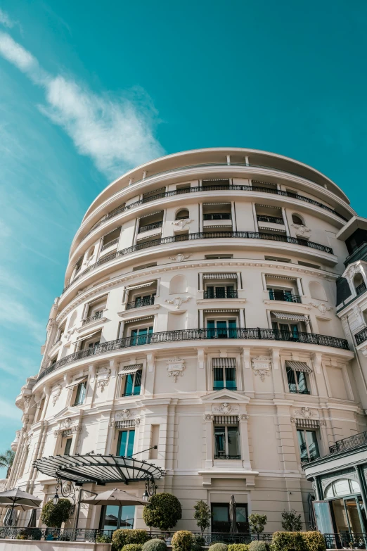 an older white building has a round staircase