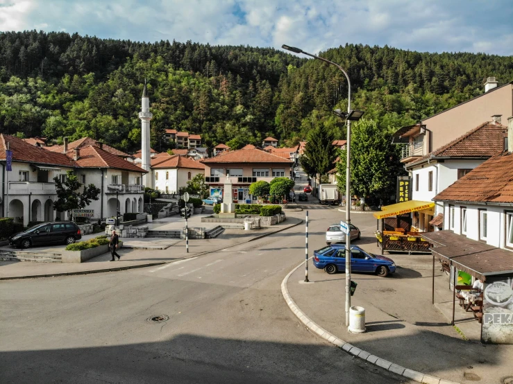 a town street with a very tall steeple in the background