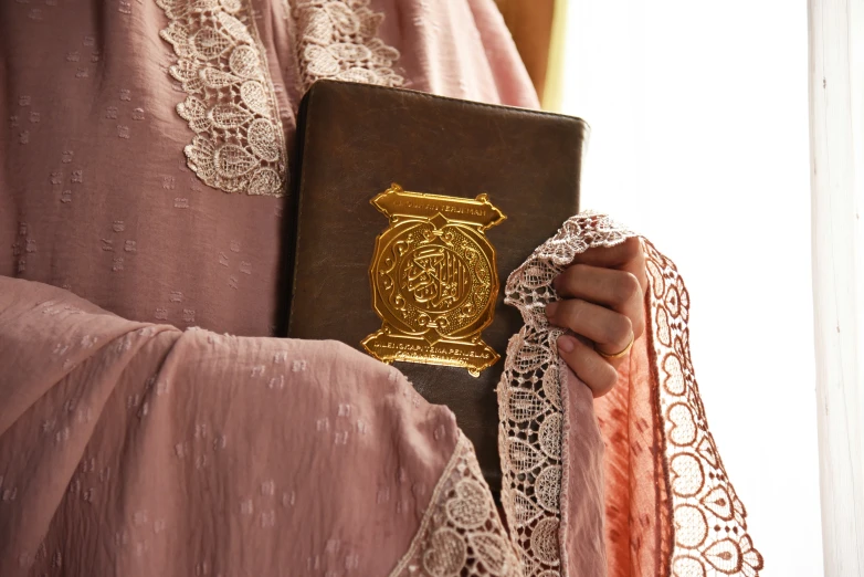 a woman in a robe and a black and gold passport