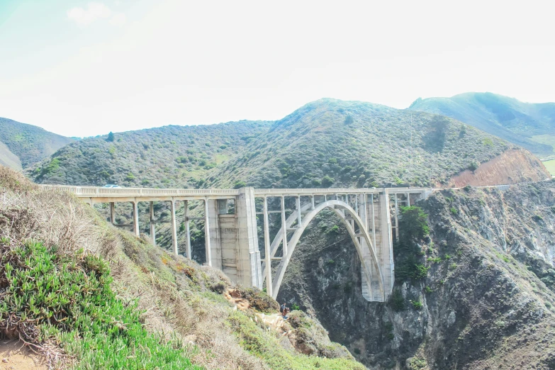 the view of a bridge on top of a mountain