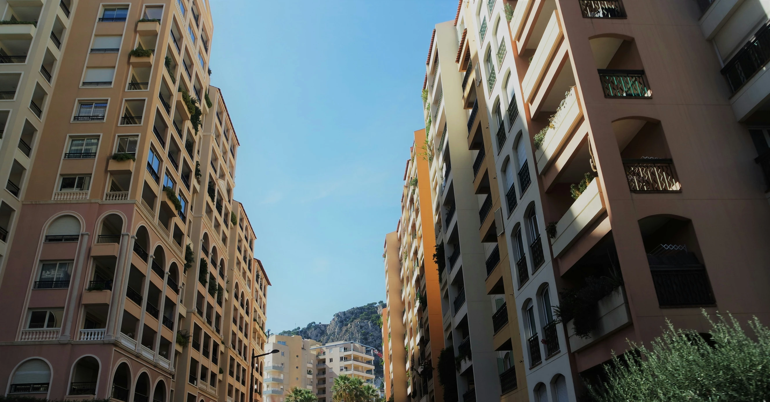 a group of people in cars walking among some tall buildings