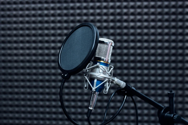 a black microphone on a tripod in a recording studio