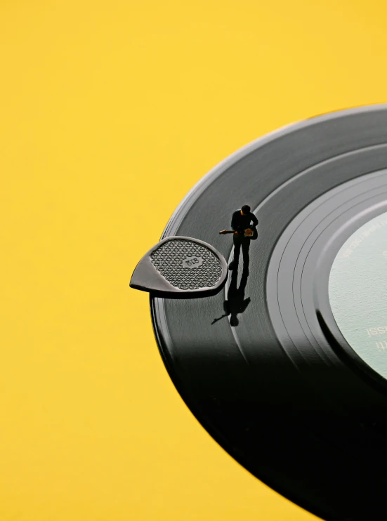 there is a small tiny figurine on a record