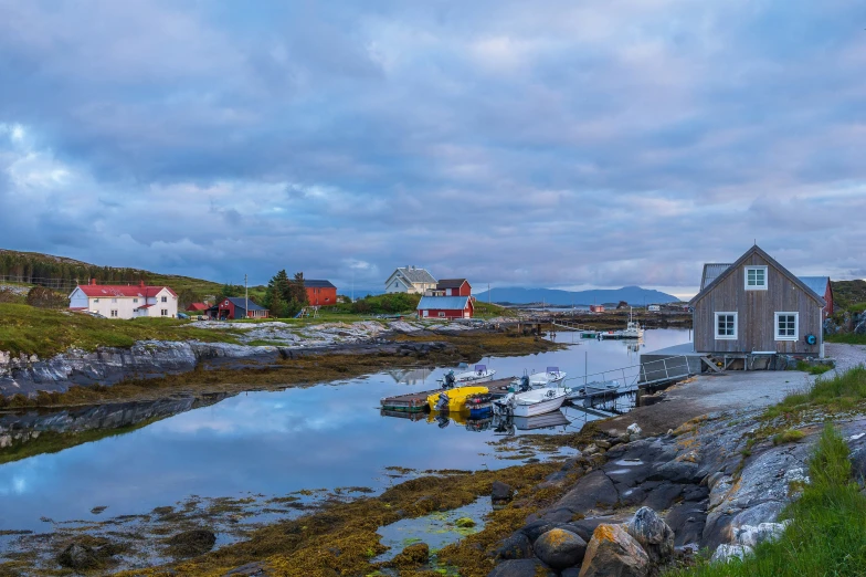 a few boats are tied to a rocky shore