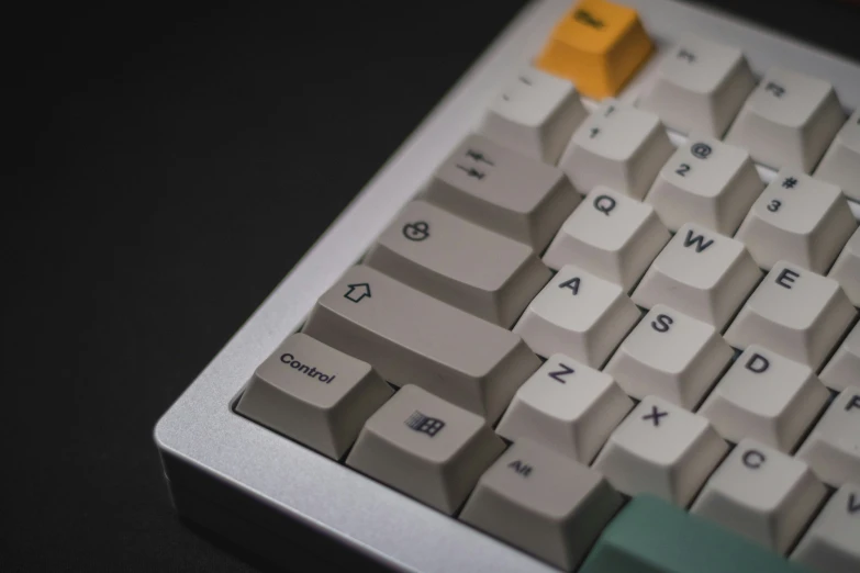 a white and grey keyboard with an orange key