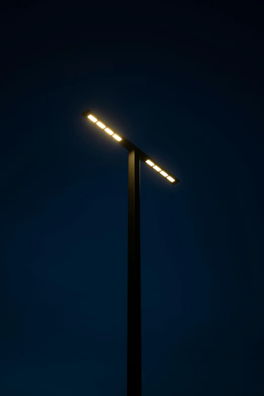 the top of a pole has a lit up light on it