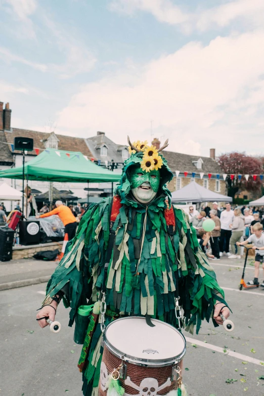 a person dressed in costumes and holding a drums