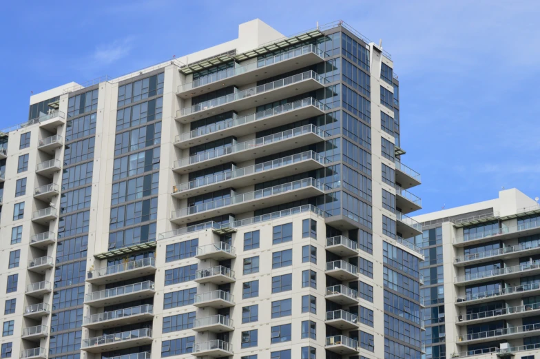 a tall white building sitting in front of a sky background