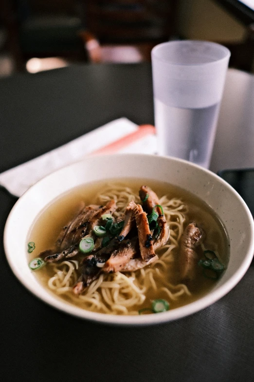 a bowl of food and a cup on a table