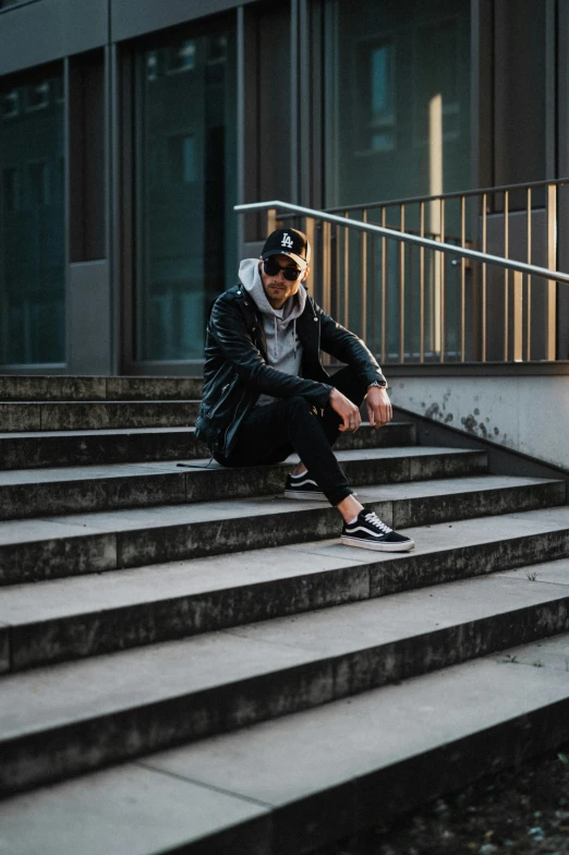 a man sitting on steps next to the stairs