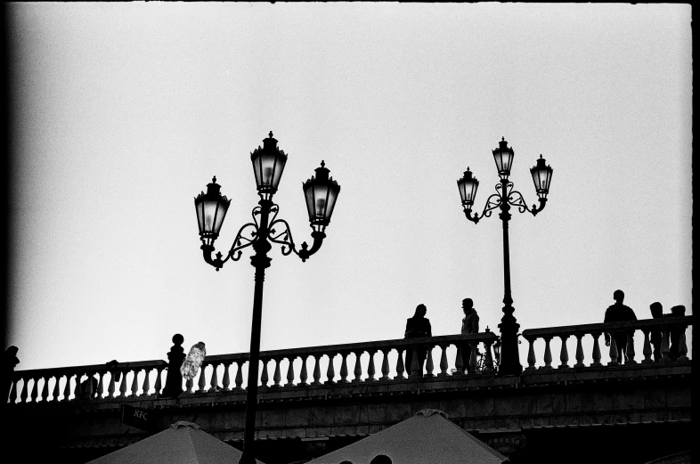 people walking across the bridge to cross the river