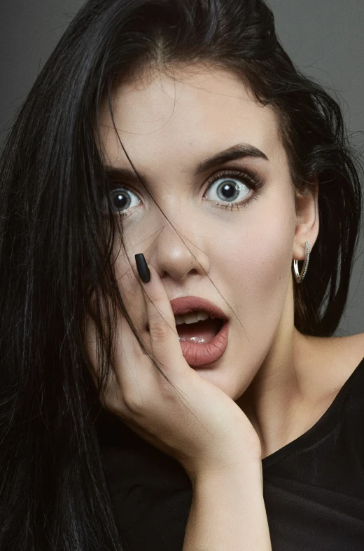 a woman posing with her hand to her face