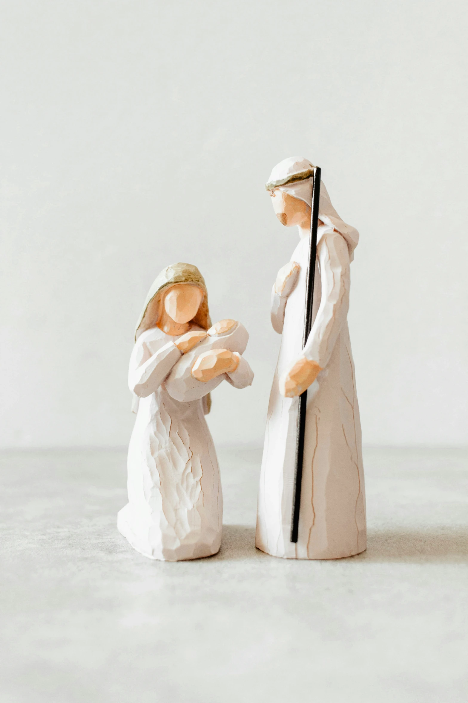 a small figurine of two people with a wand