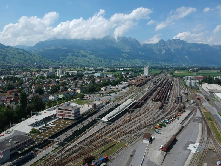 an aerial view of a train yard on a cloudy day