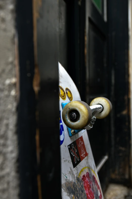 a white skateboard with some stickers on it's board