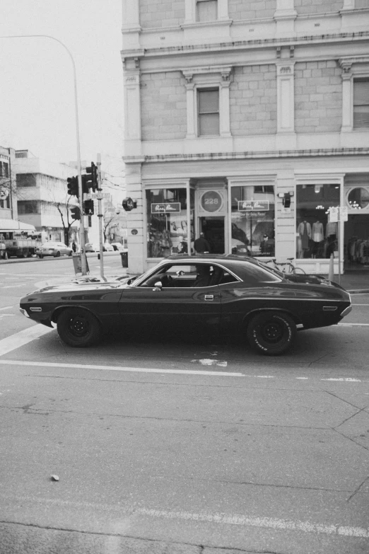 an old car sitting on the side of a road