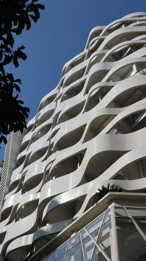 a tall building that is white with multiple windows