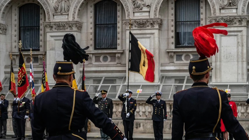 two men in uniforms with red and black flags