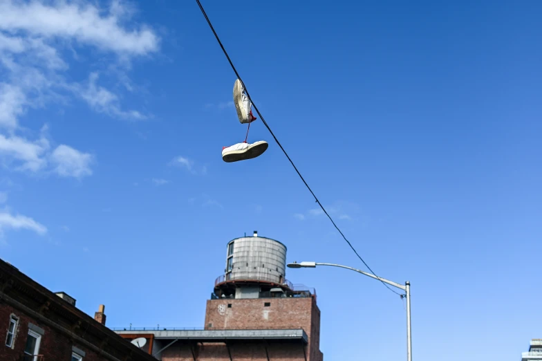 two shoes on power lines over a city street