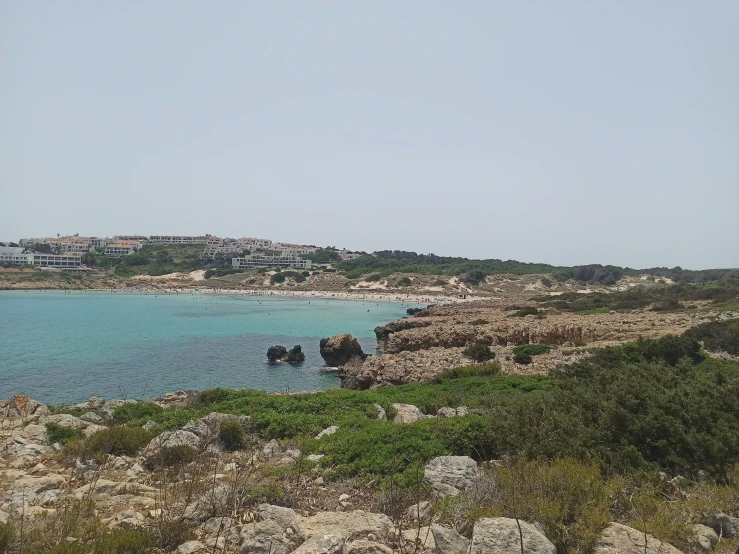 a view of the ocean with small boats near by