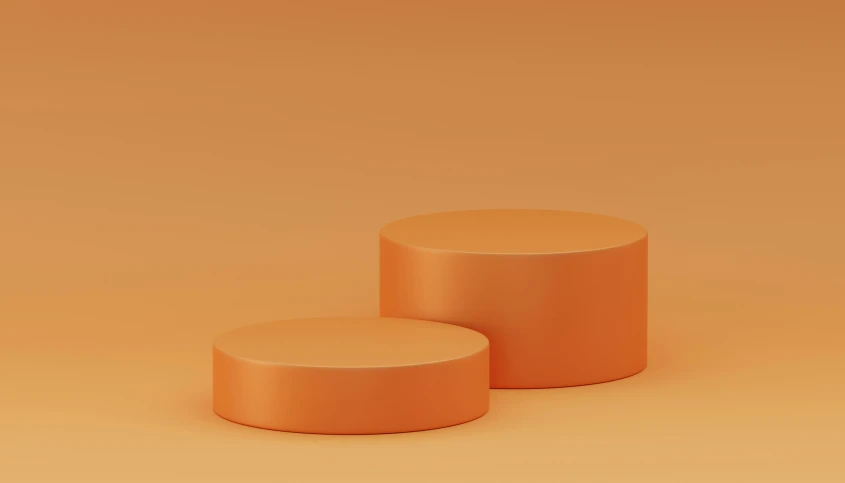 two cylindrical orange stools on an orange background