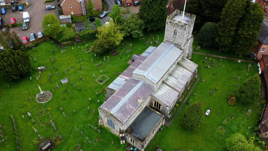 an aerial view of an old cemetery with trees, and graveyards
