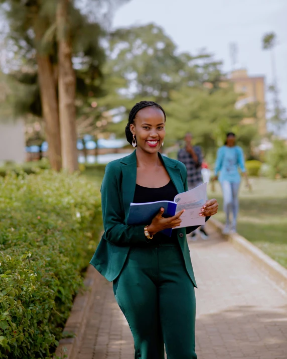 a woman is looking at a work folder while smiling