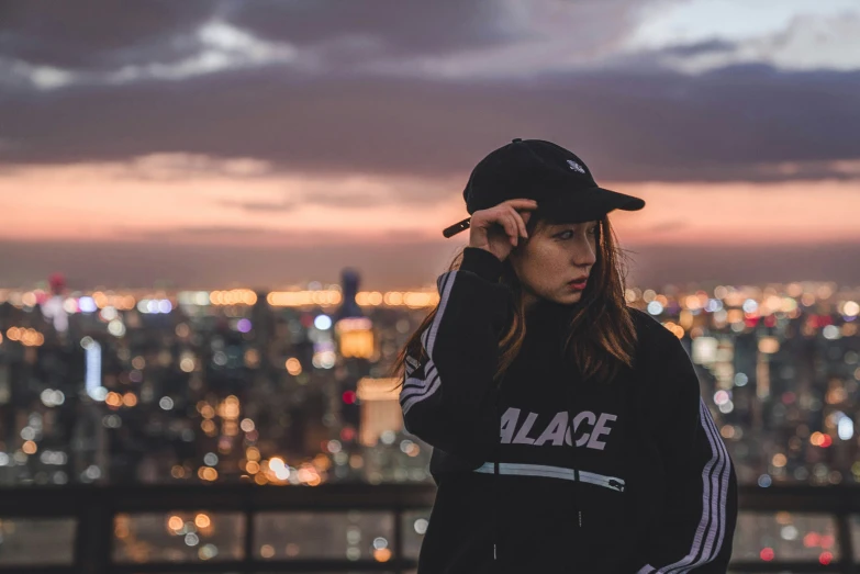 a woman standing with a city skyline in the background