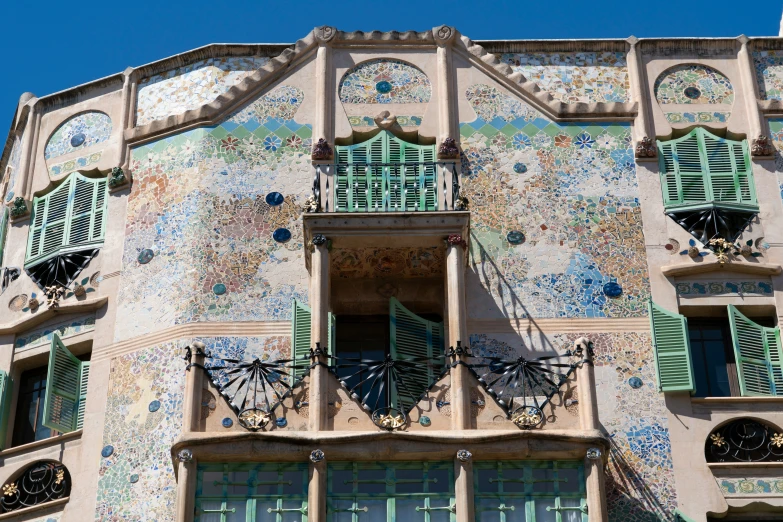 a building with a wrought iron balcony and stained glass windows