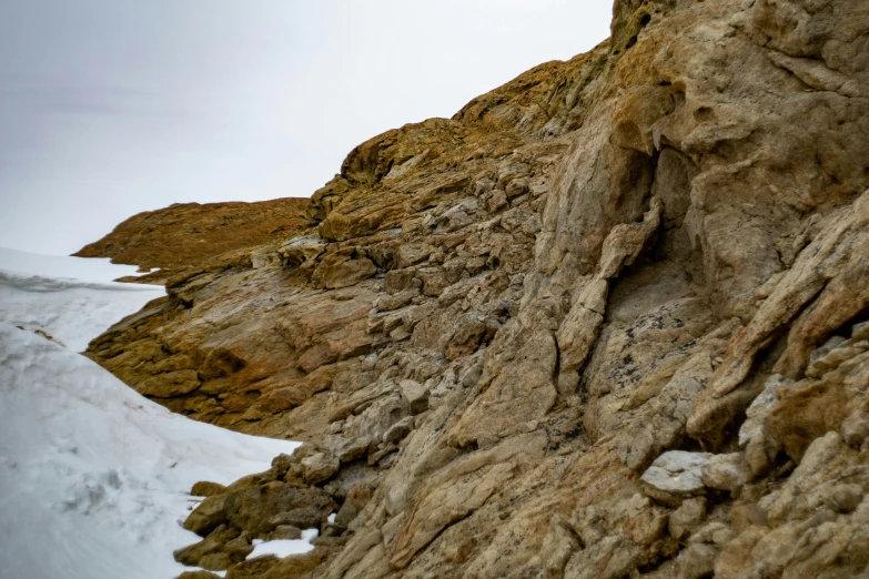 a rock wall in a snow field