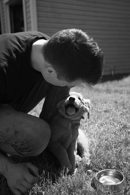 a man playing with a dog on top of a field