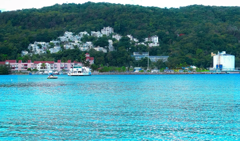 blue water with boats in the water and the city in the background