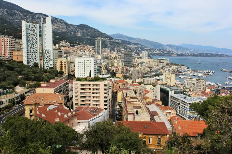 a city overlooks the ocean and mountains